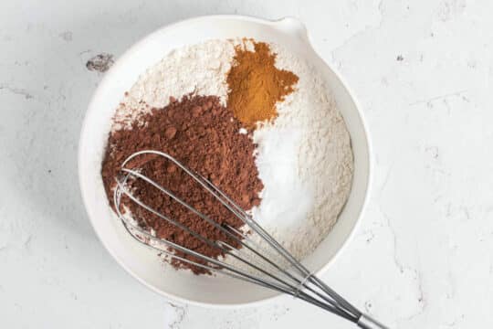 Whisking flour with cocoa powder and cinnamon.