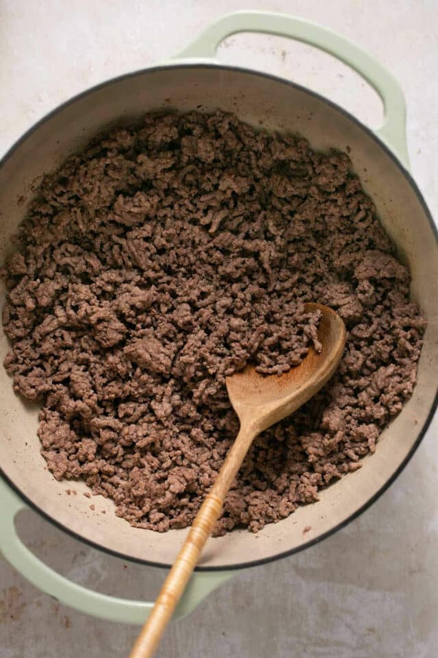 Browning ground beef in a large pan.