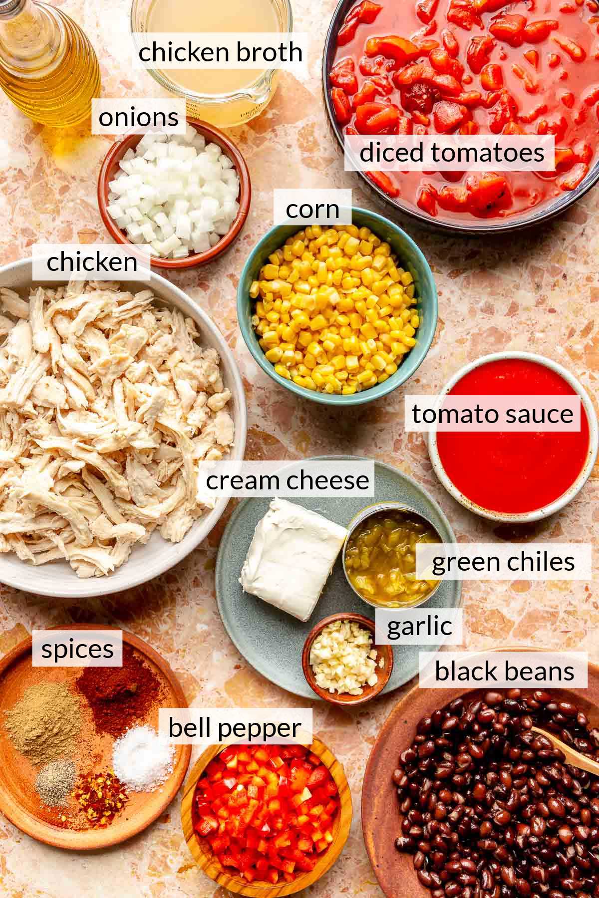 Bowls filled with ingredients for chicken chili. 