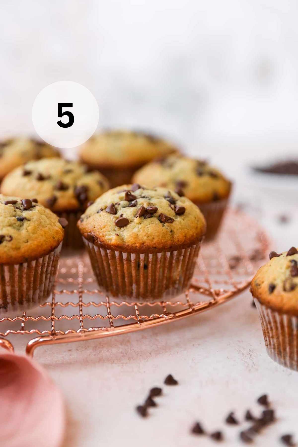 Chocolate chip banana muffins on a wire rack.