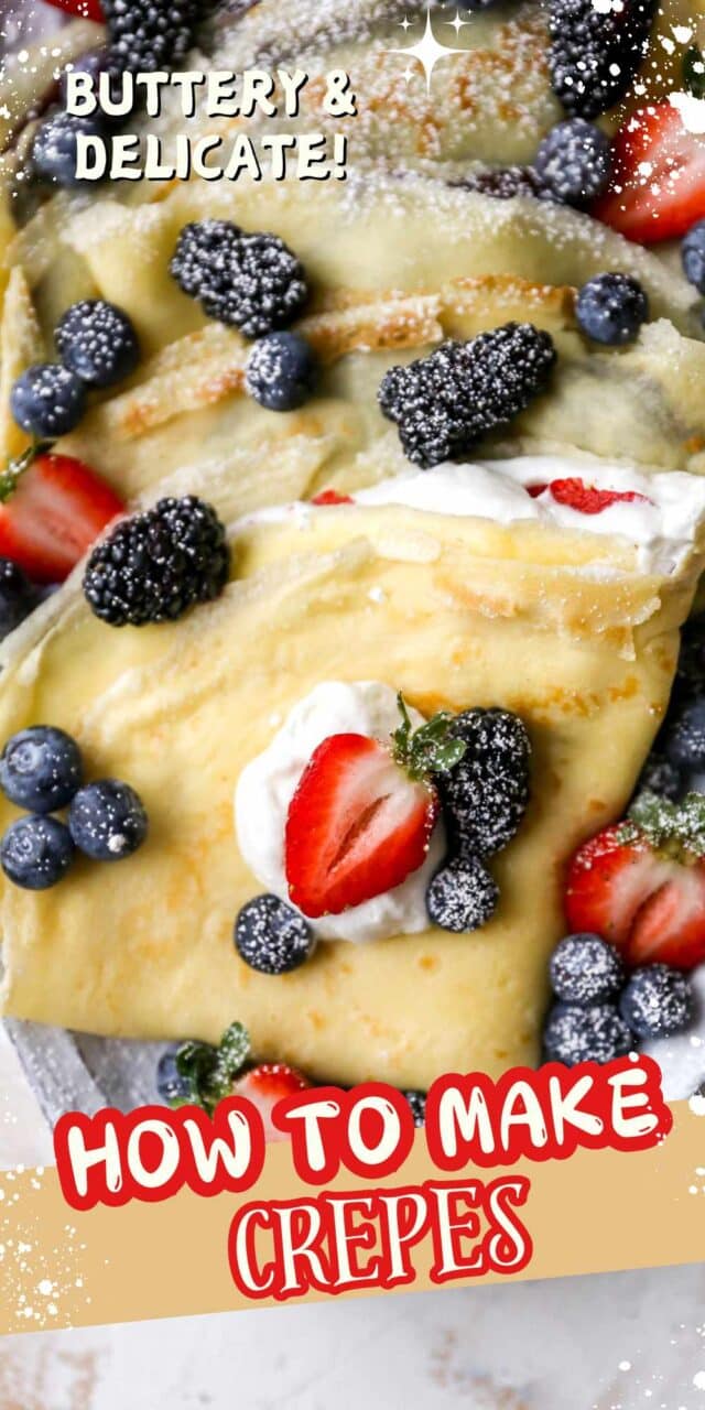 Folded crepe on a white plate, filled with whipped cream and topped with fresh berries.