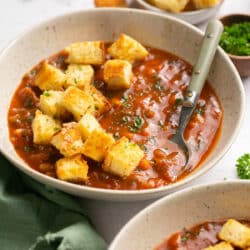 Garden vegetable soup topped with croutons.