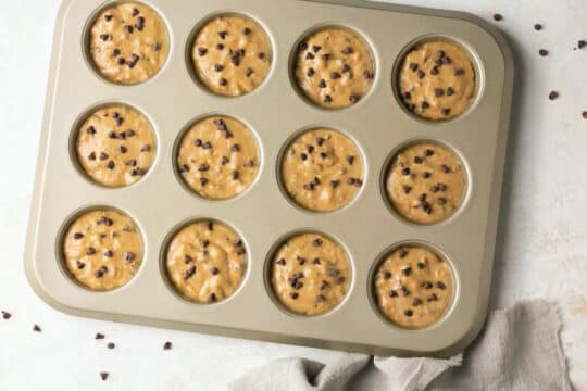 Pancake muffin batter in a muffin pan.