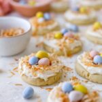 Bird's nest easter cookies with frosting, toasted coconut and mini Cadbury eggs.