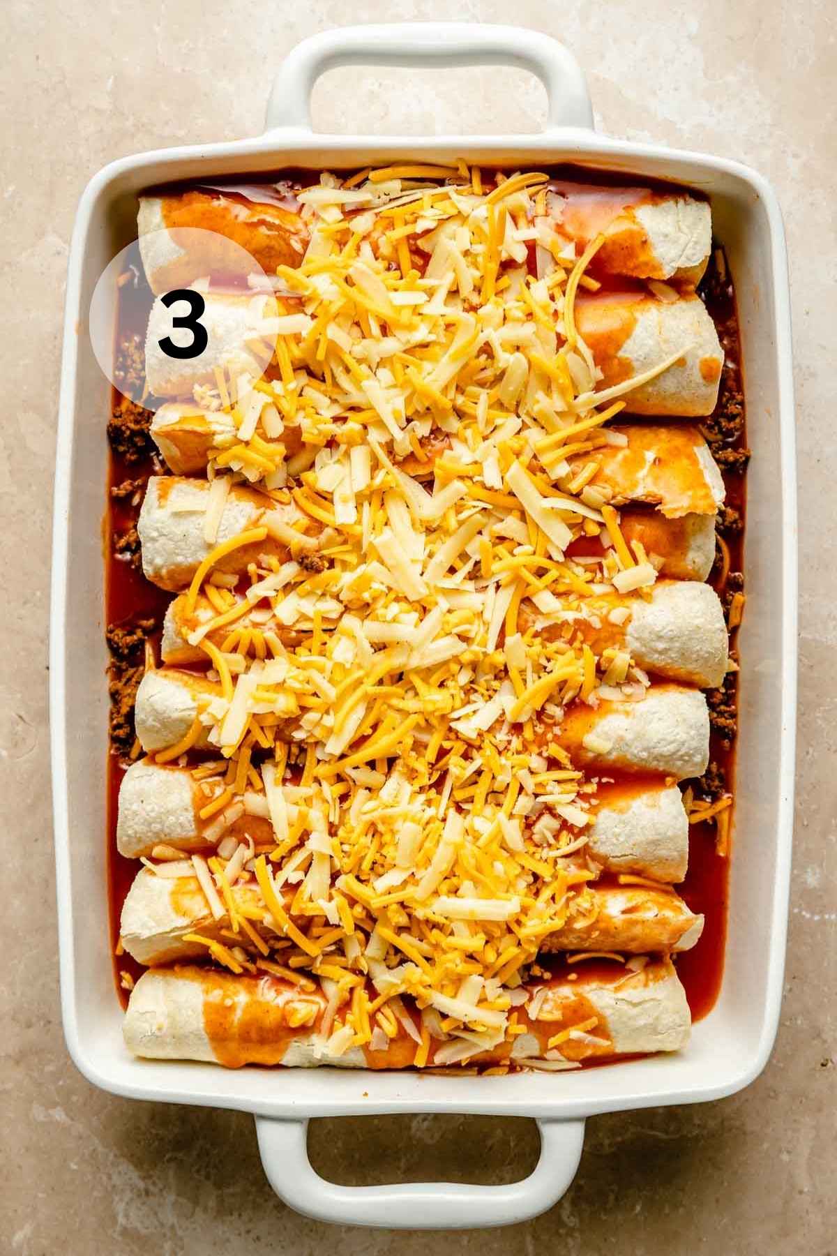 Tortillas rolled up in a dish and topped with enchilada sauce and shredded cheese.