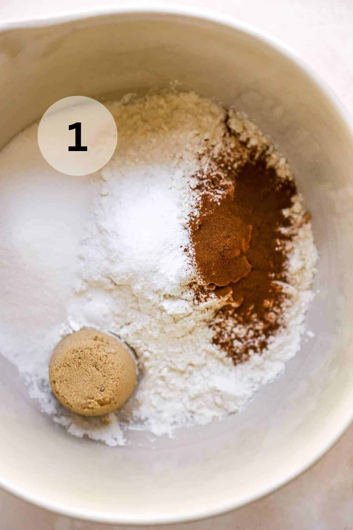 Adding flour, cinnamon, baking powder, and sugar to a large bowl.