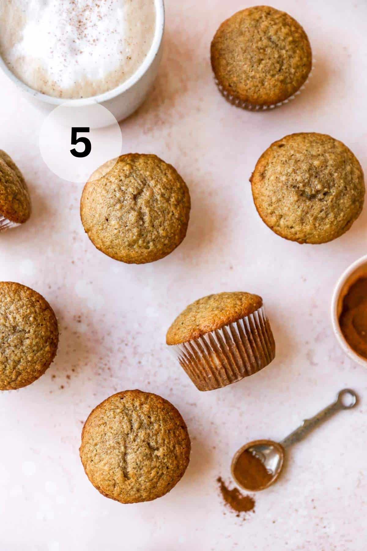 Banana muffins near ground cinnamon.