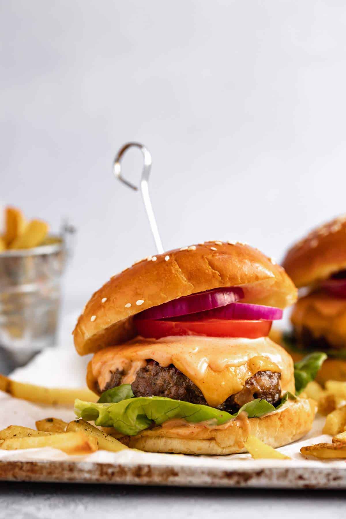 Cheese stuffed burger served with French fries.