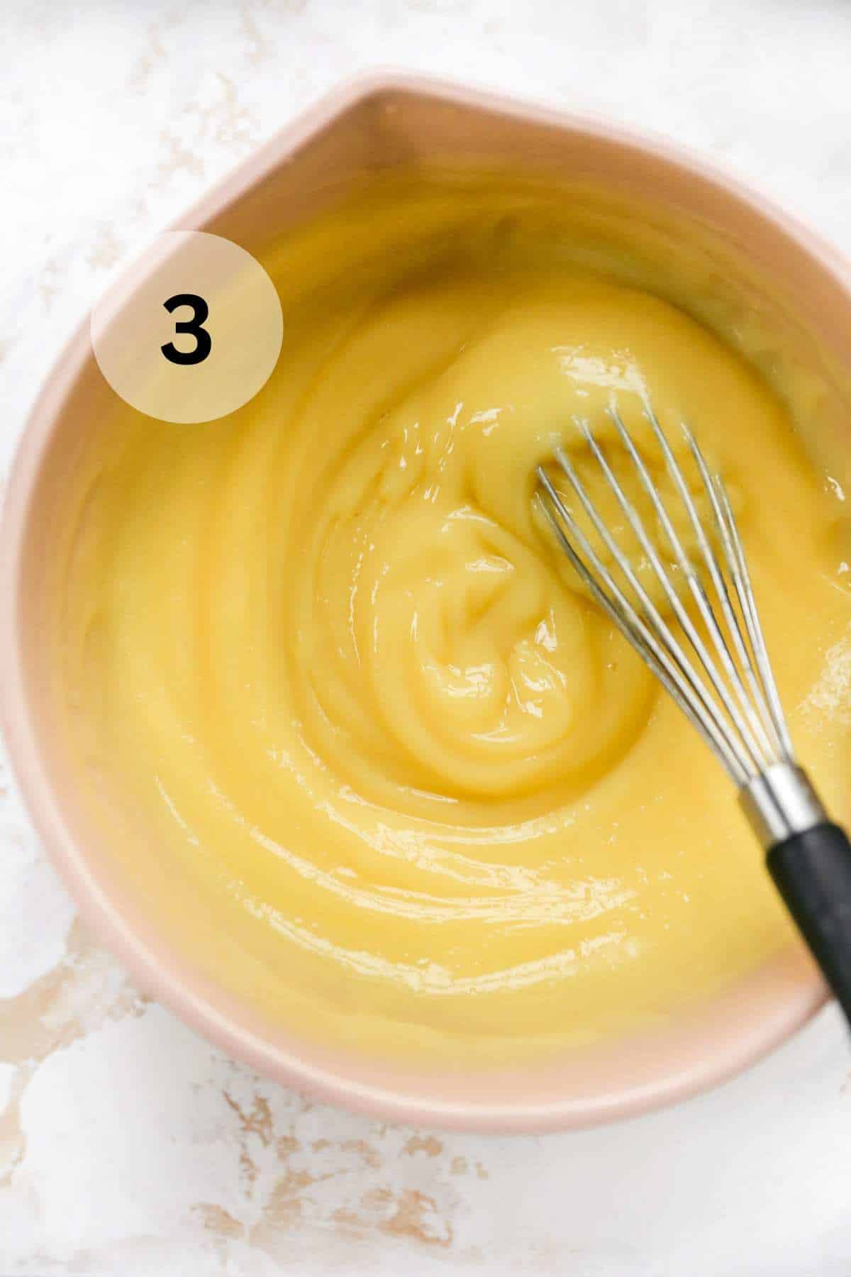 Whisking vanilla pudding with milk.