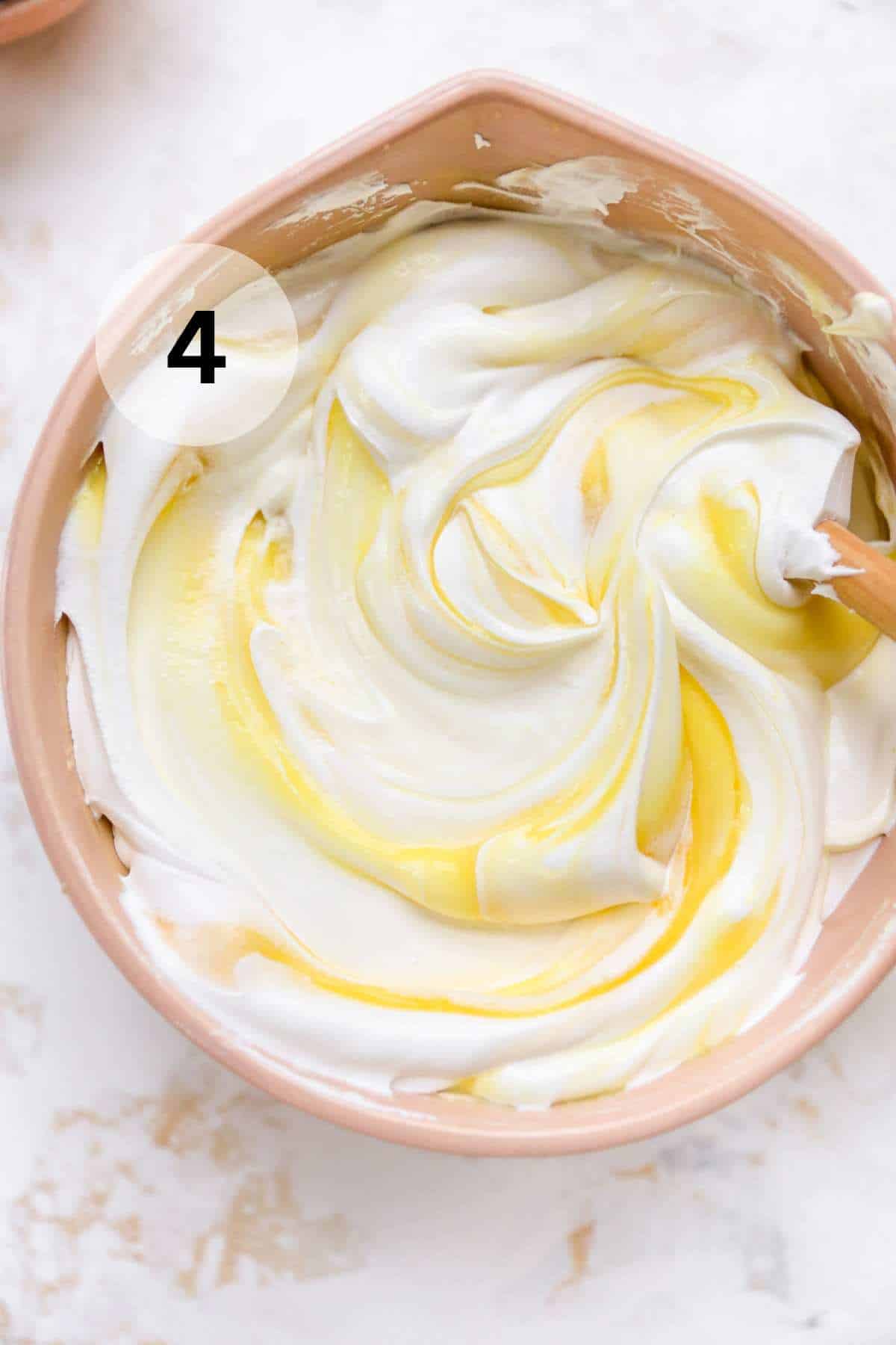 Stirring vanilla pudding with Cool Whip.