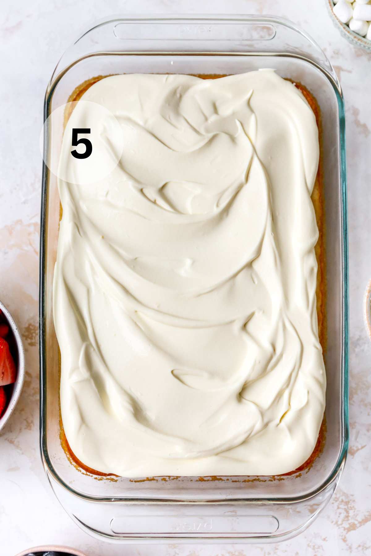 Whipped topping spread over a sheet cake.