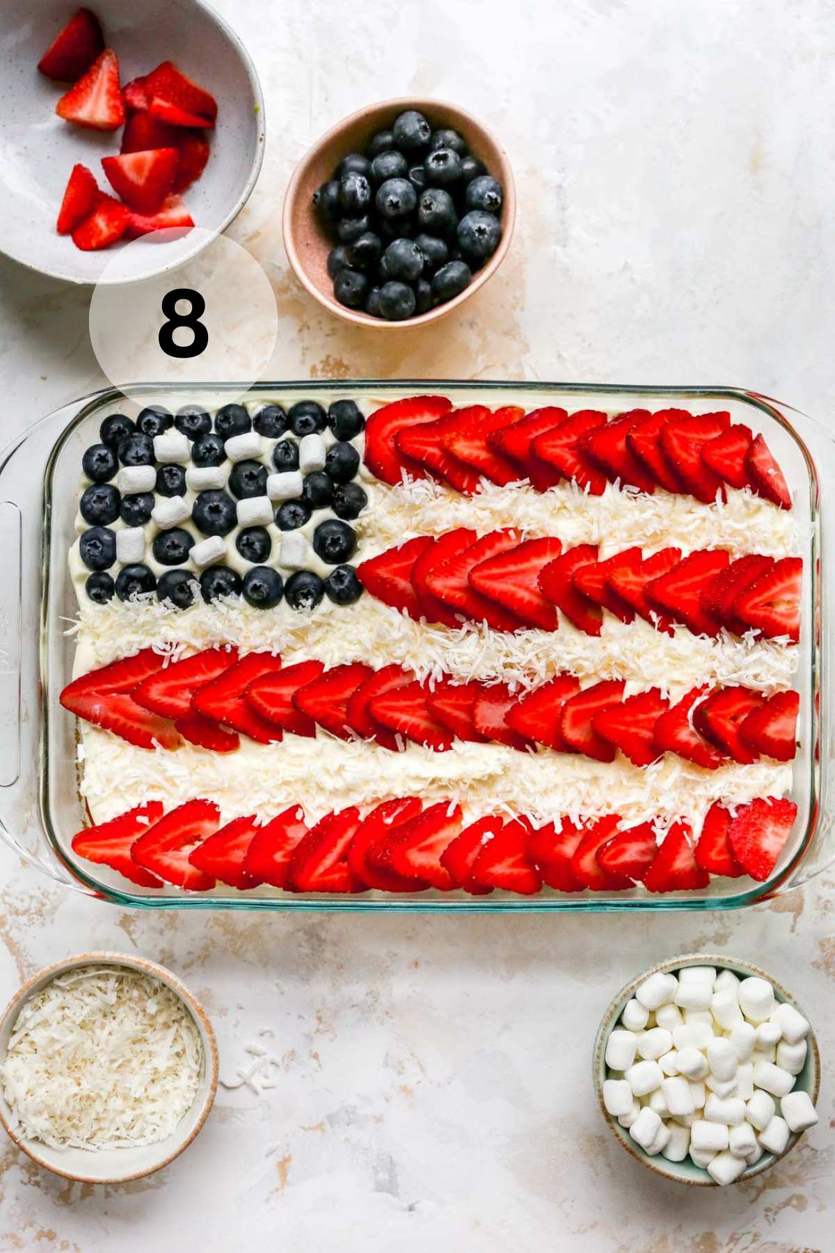 Adding shredded to coconut to make lines on a flag cake.