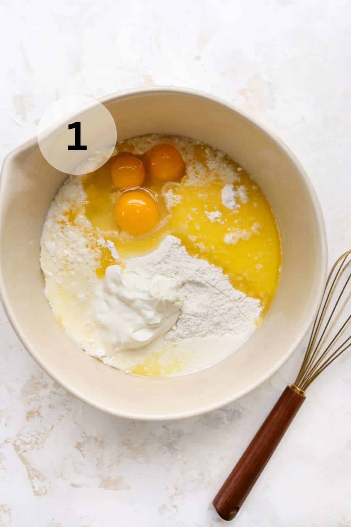 Mixing eggs and sour cream with cake mix in a large bowl.