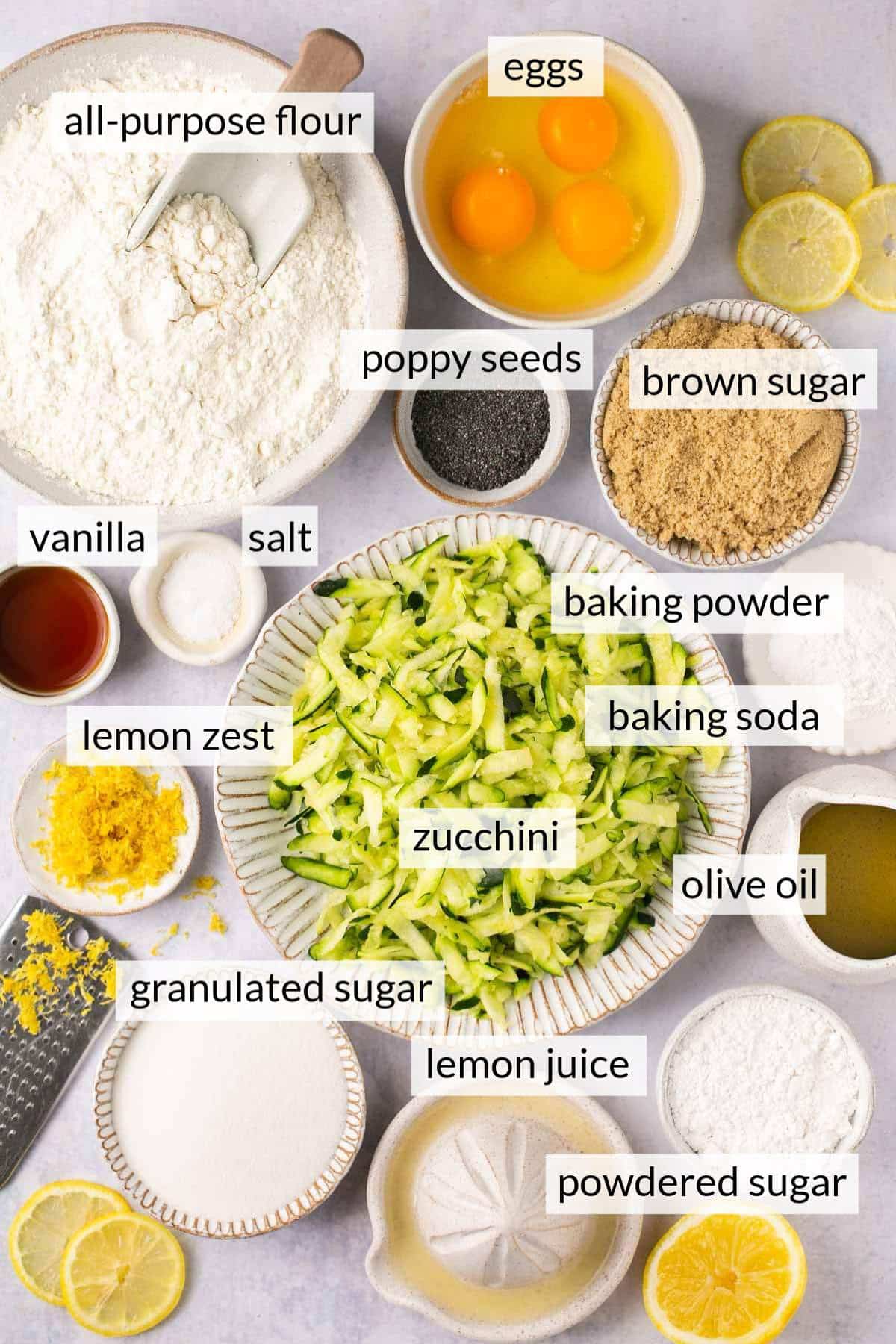 Shredded zucchini and other ingredients divided into small bowls.