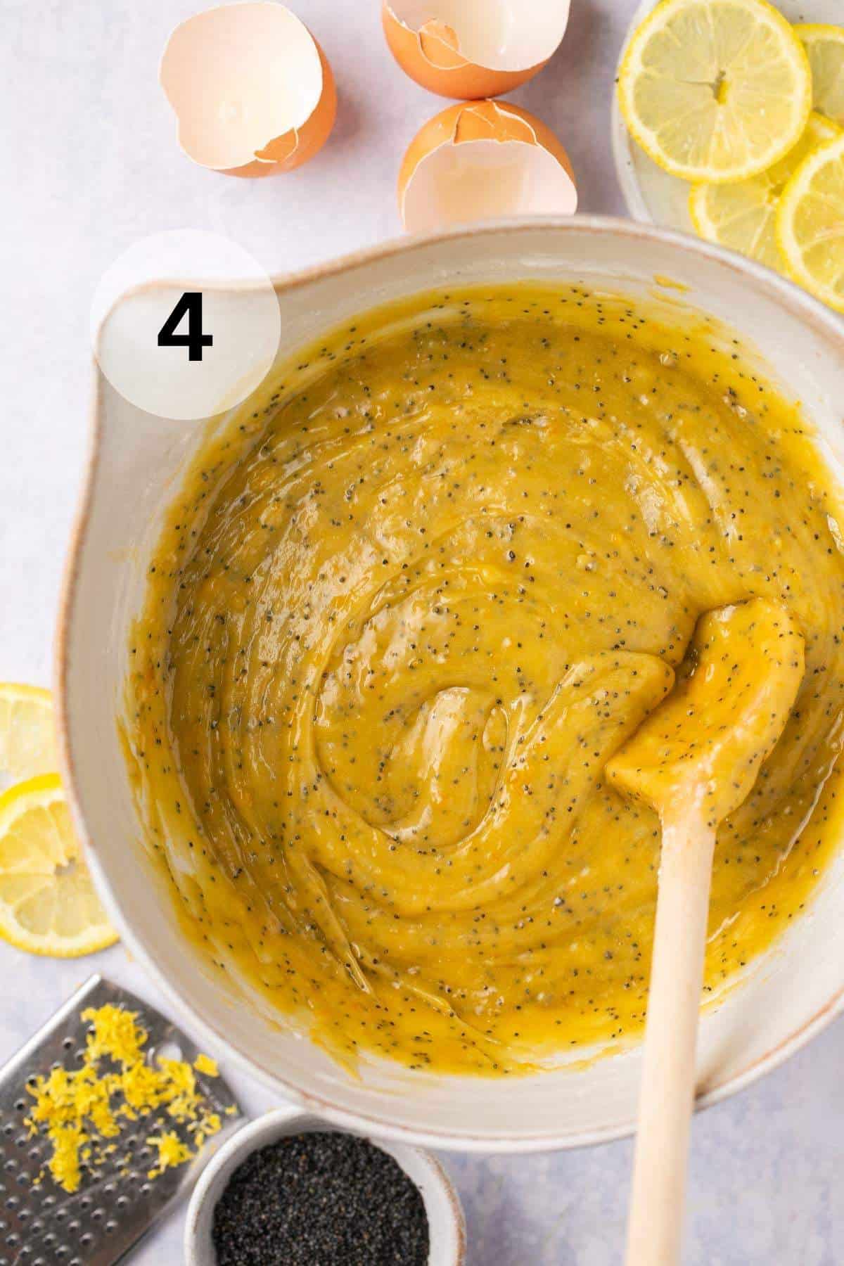 Stirring batter for lemon zucchini bread in a large bowl.