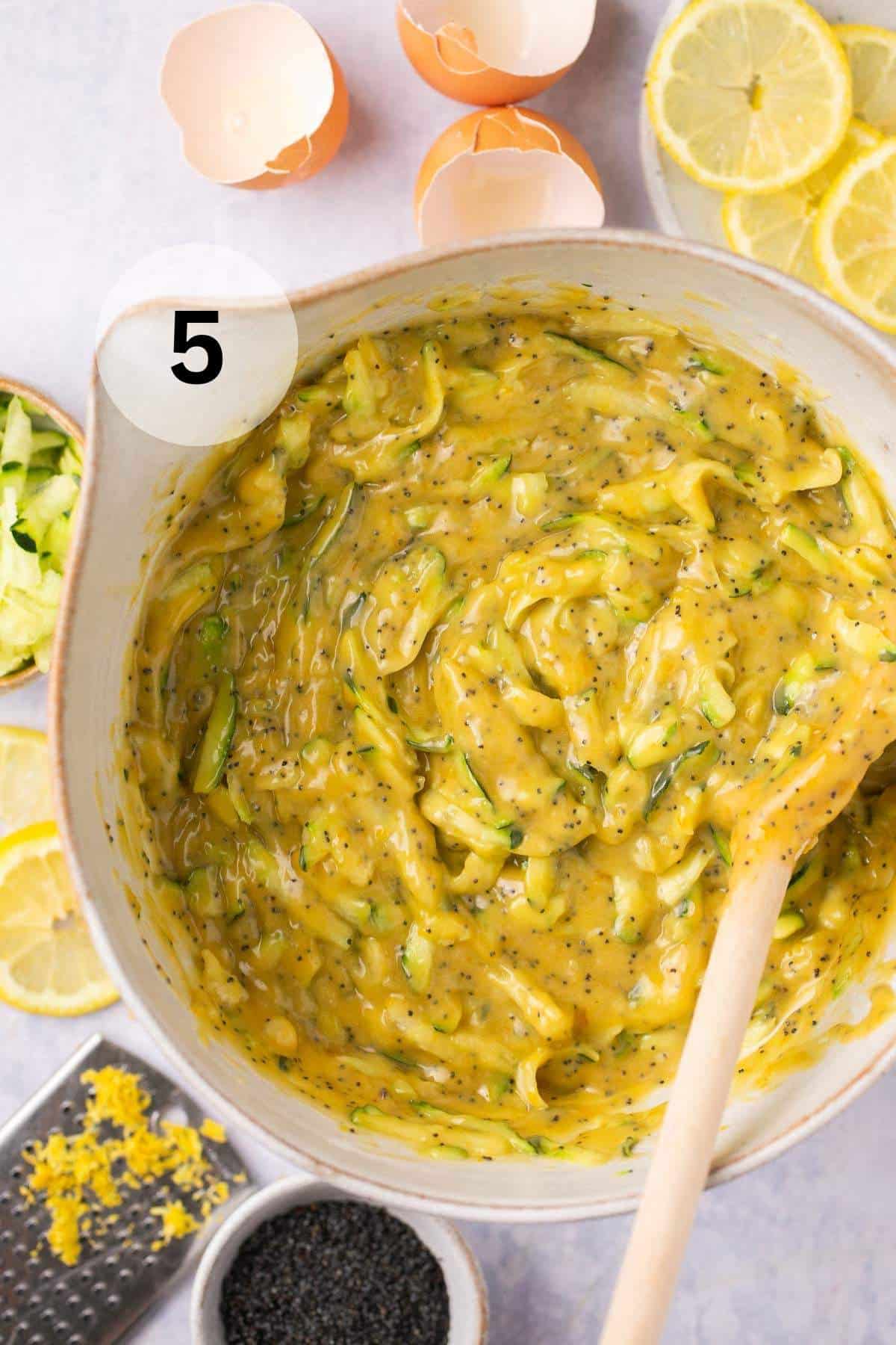 Stirring zucchini into batter.