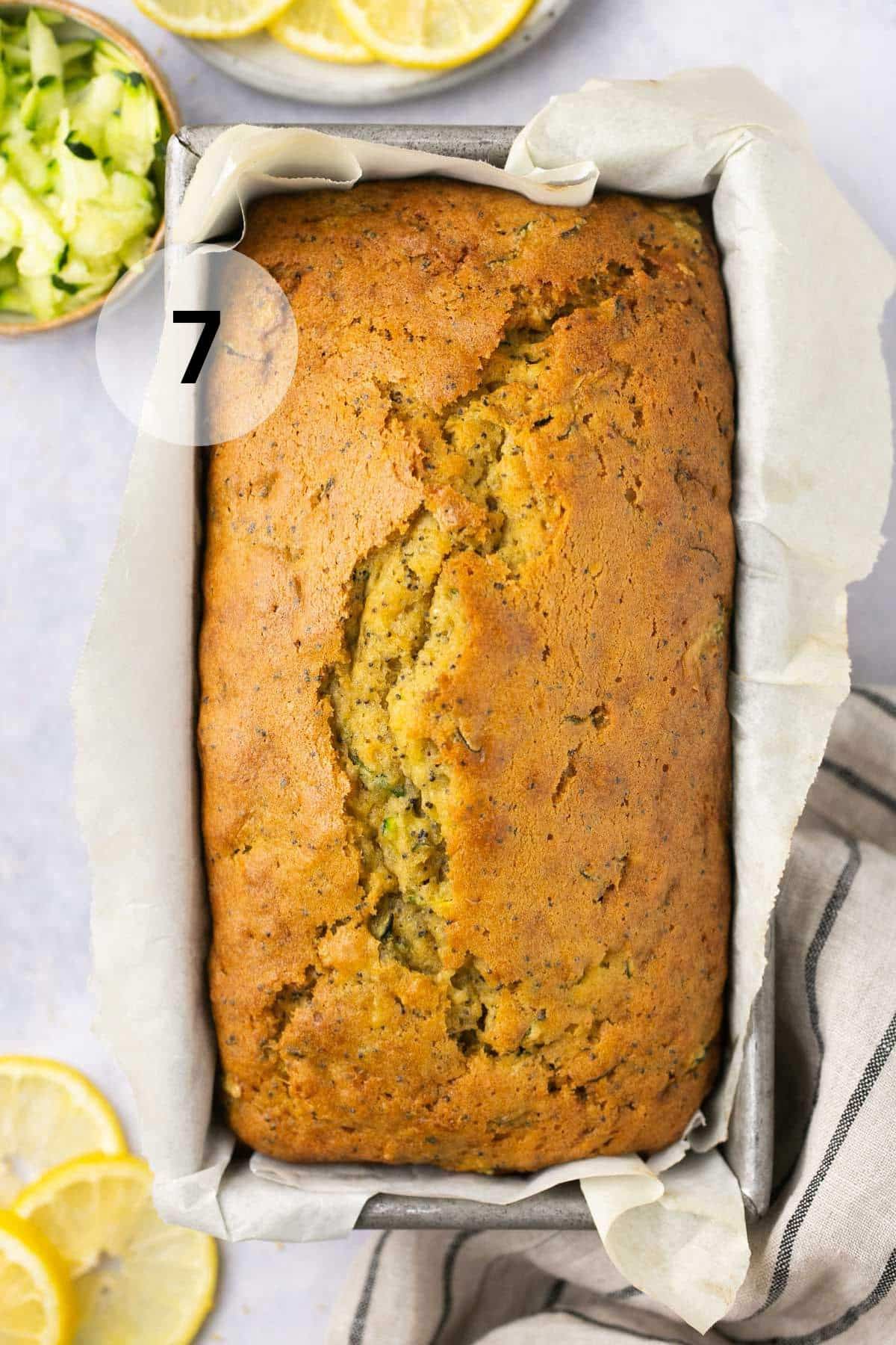 Loaf of quick bread in a parchment-lined loaf pan.