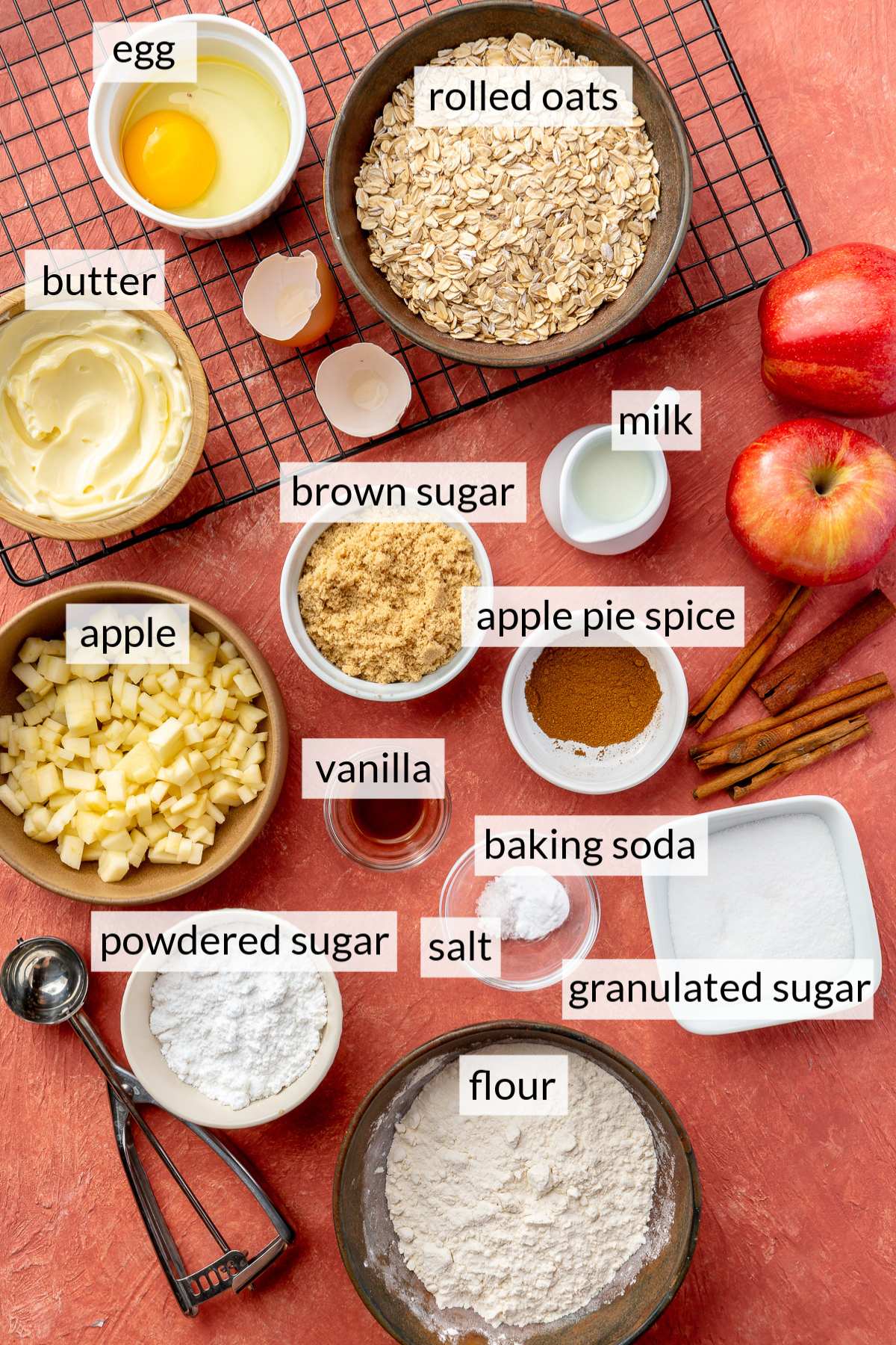 Small bowls with flour, oats, egg, chopped apple, butter and sugar.