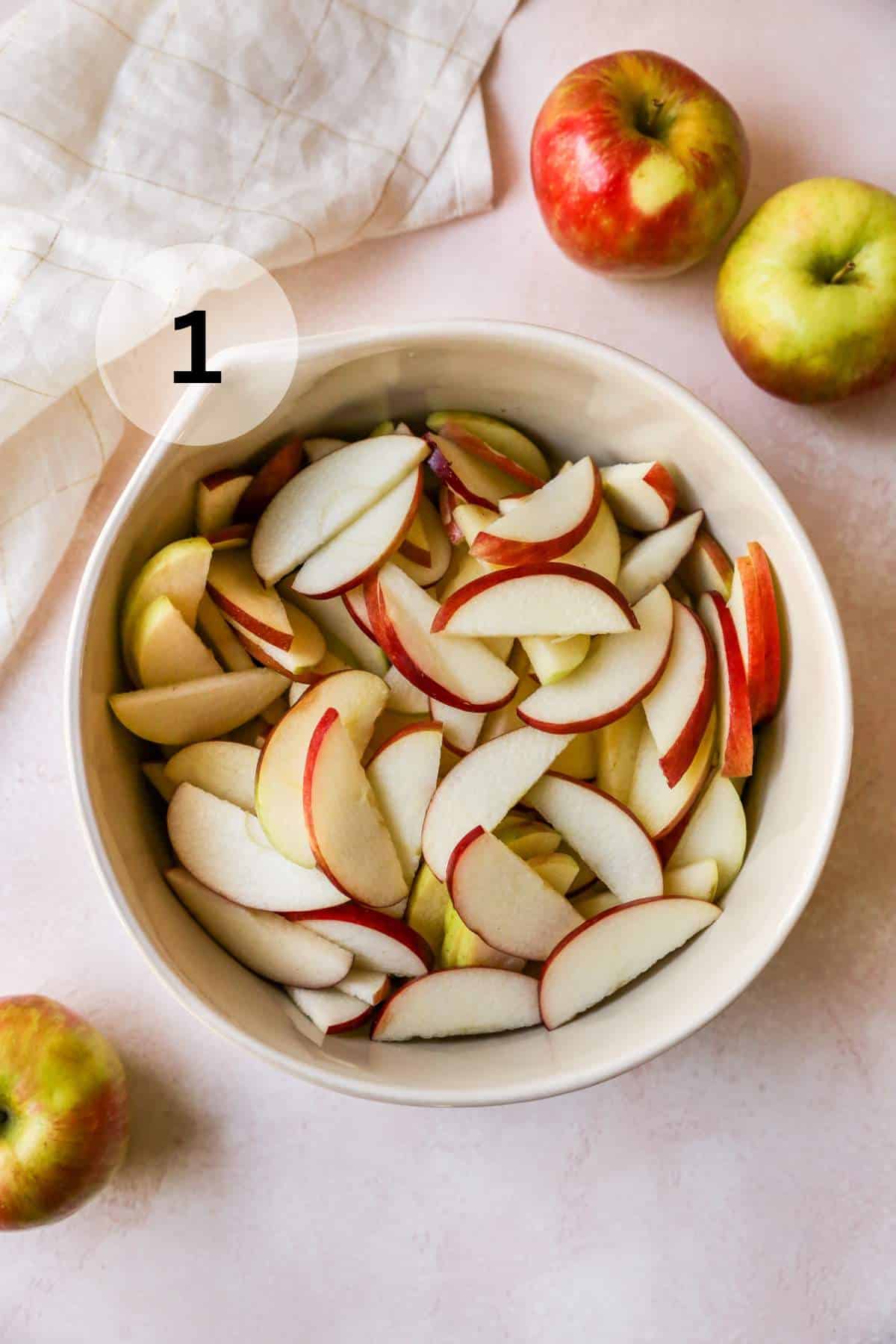 Apple slices in a large bowl.