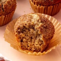 Applesauce muffins with a bite taken out of one.