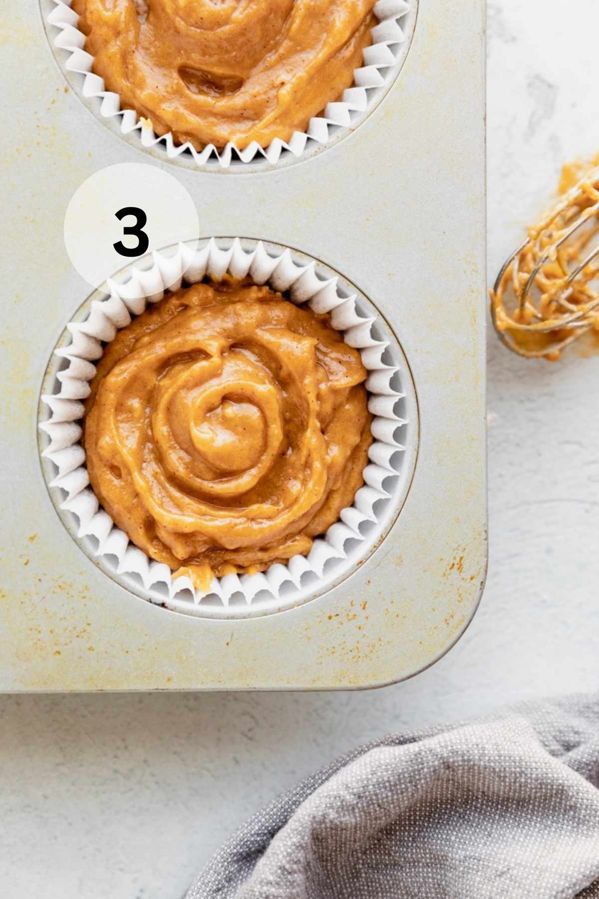 Muffin batter in a muffin pan.