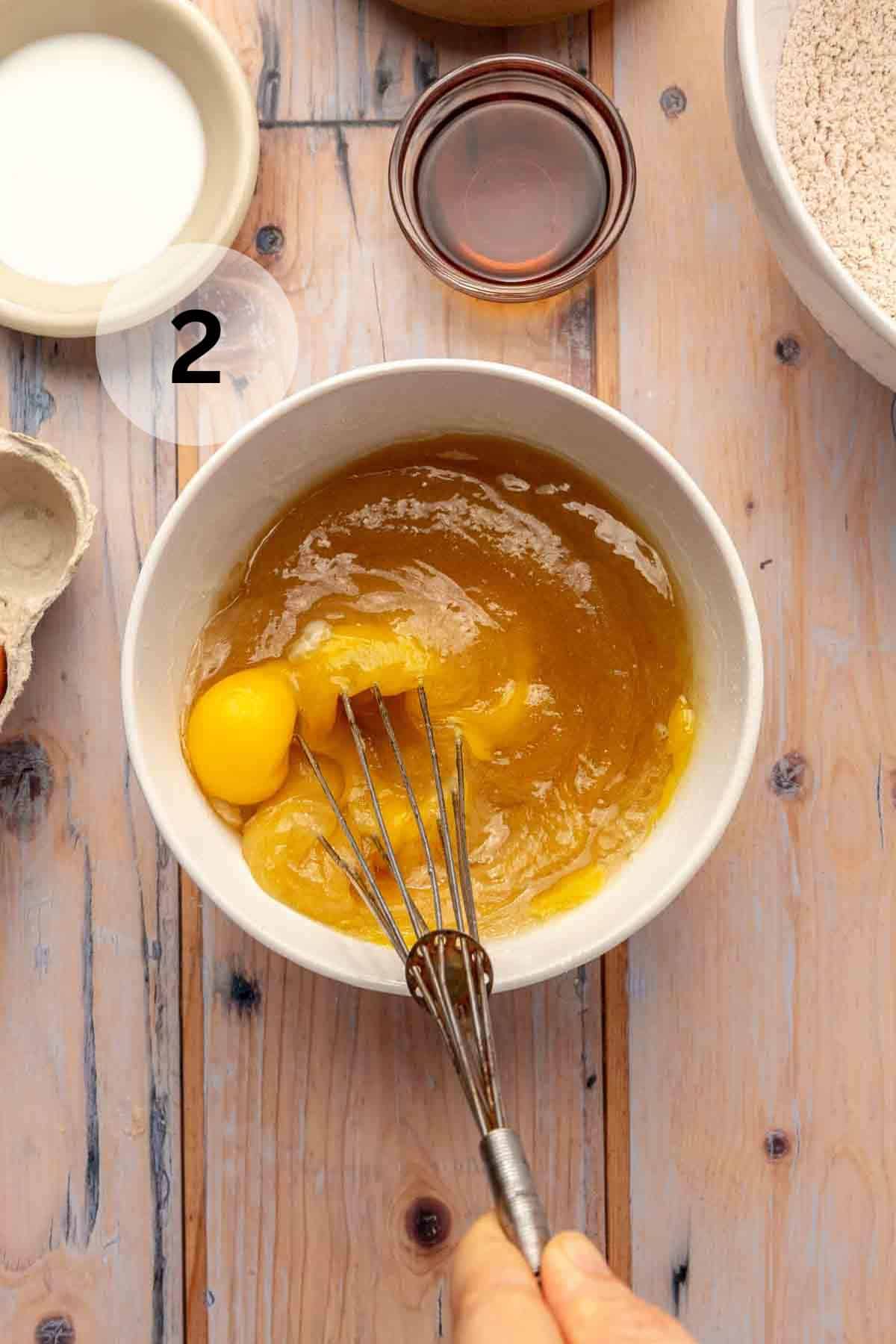 In a medium bowl, stirring the applesauce, oil, sugar, and salt with the eggs and vanilla.