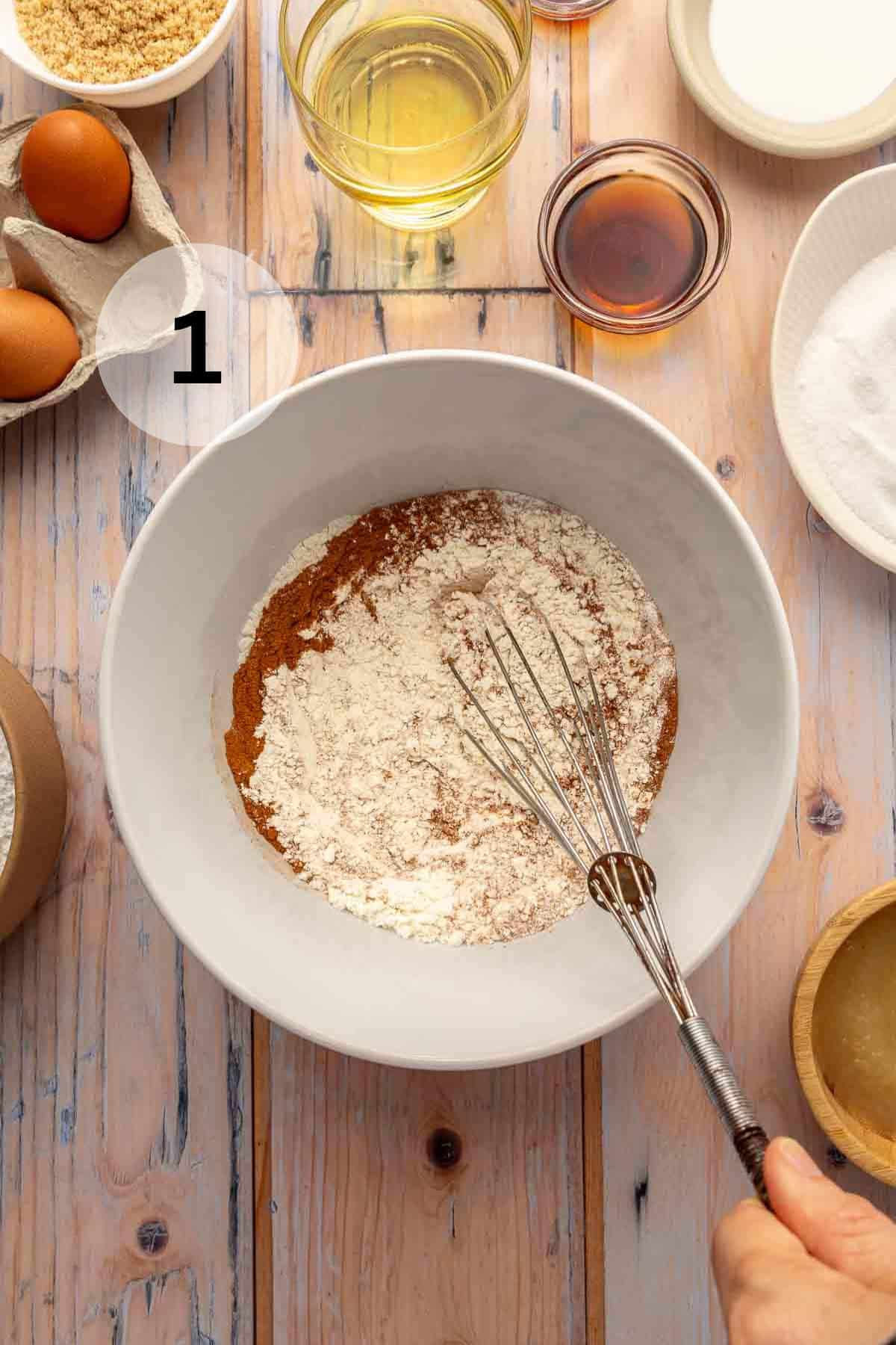 Whisking flour with cinnamon and nutmeg.