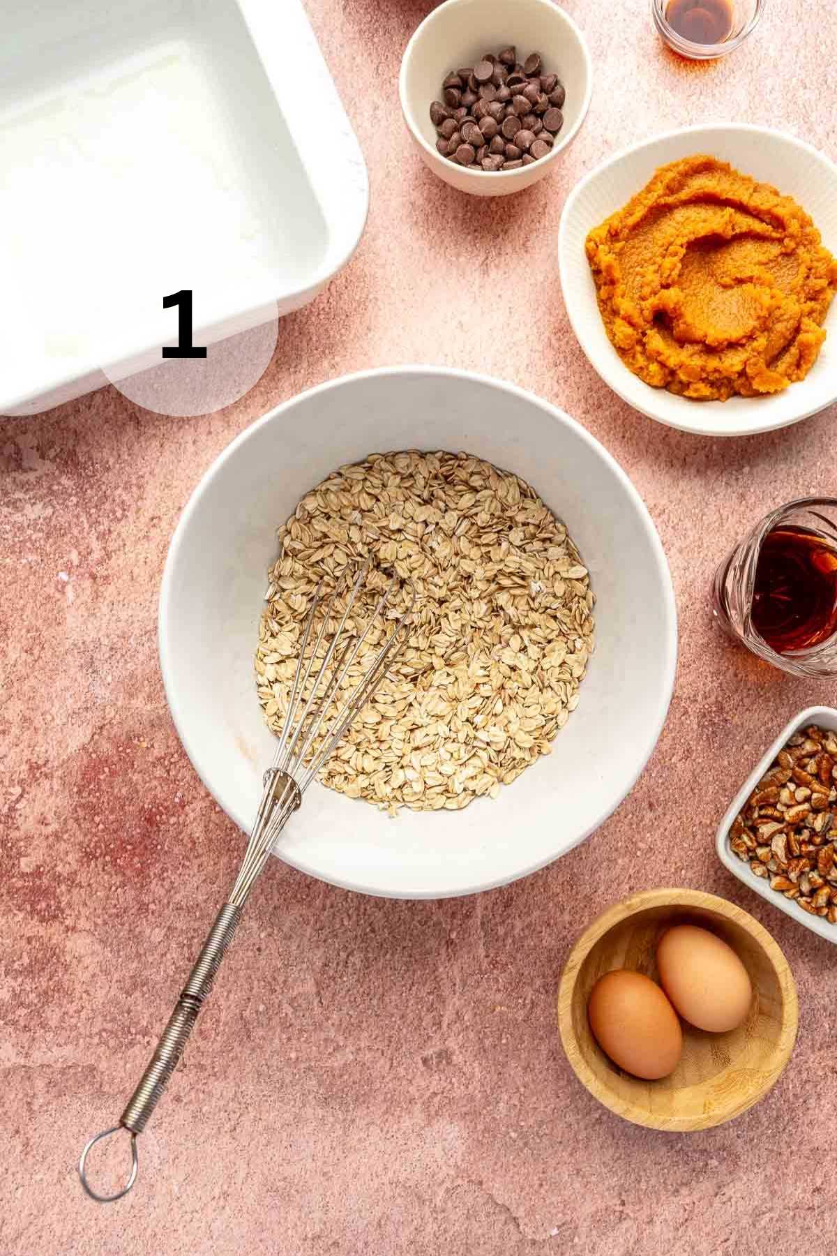 Mixing spices, salt and baking powder with rolled oats in a bowl.