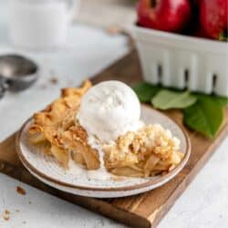 Slice of pie topped with a scoop of vanilla ice cream.