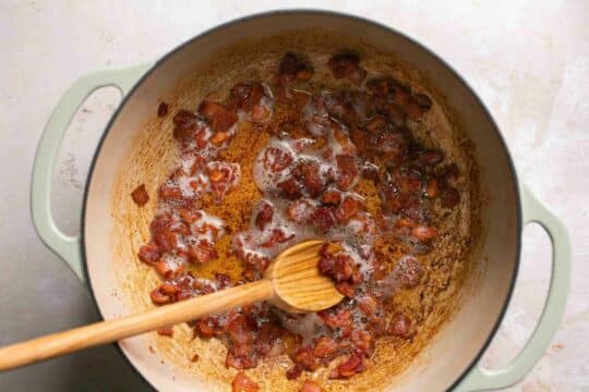 Frying bacon in a pan.