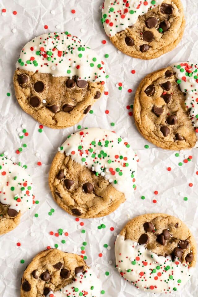 White chocolate dipped chocolate chip cookies with sprinkles.