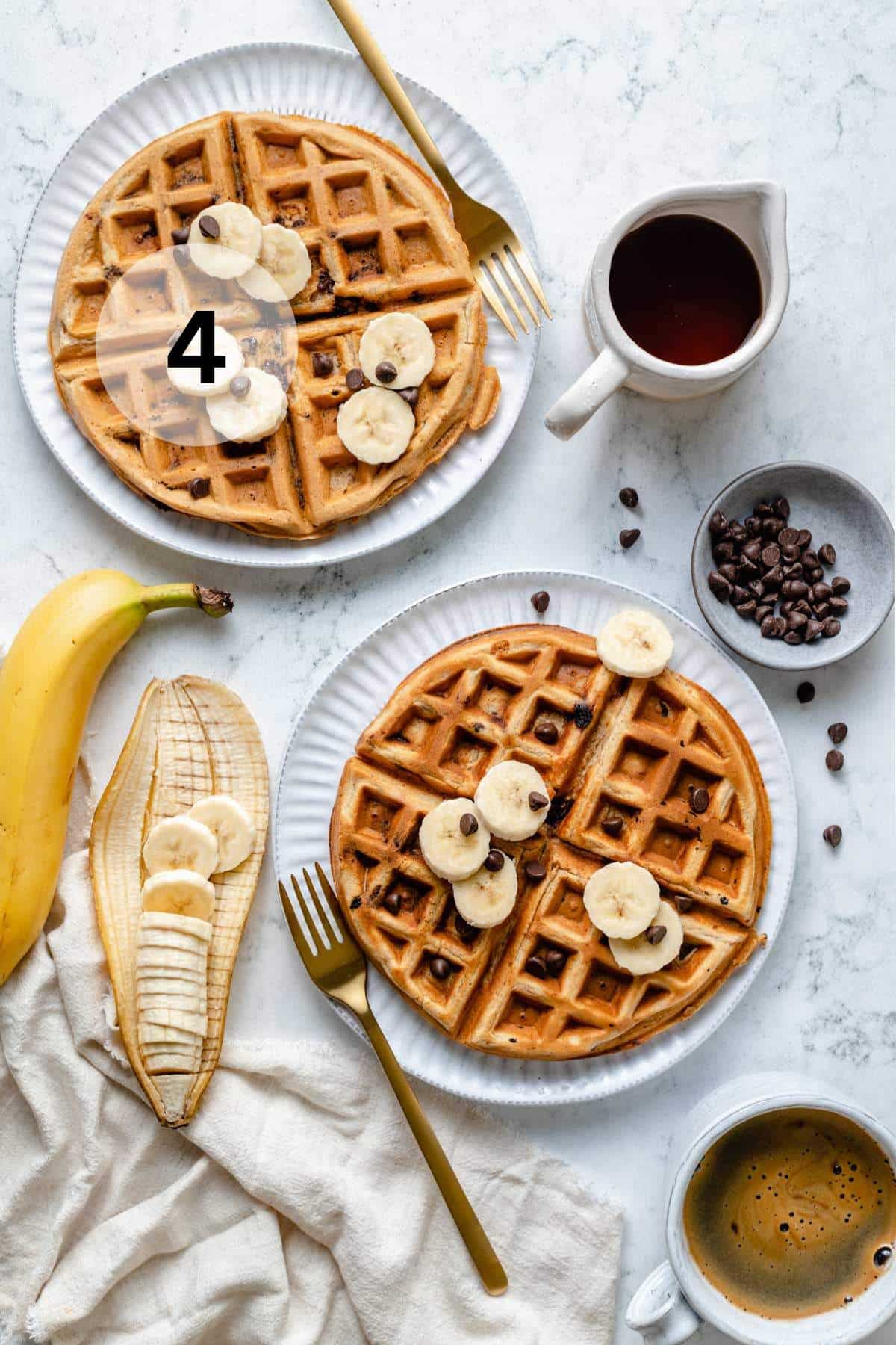 Banana waffles topped with banana slices and mini chocolate chips.