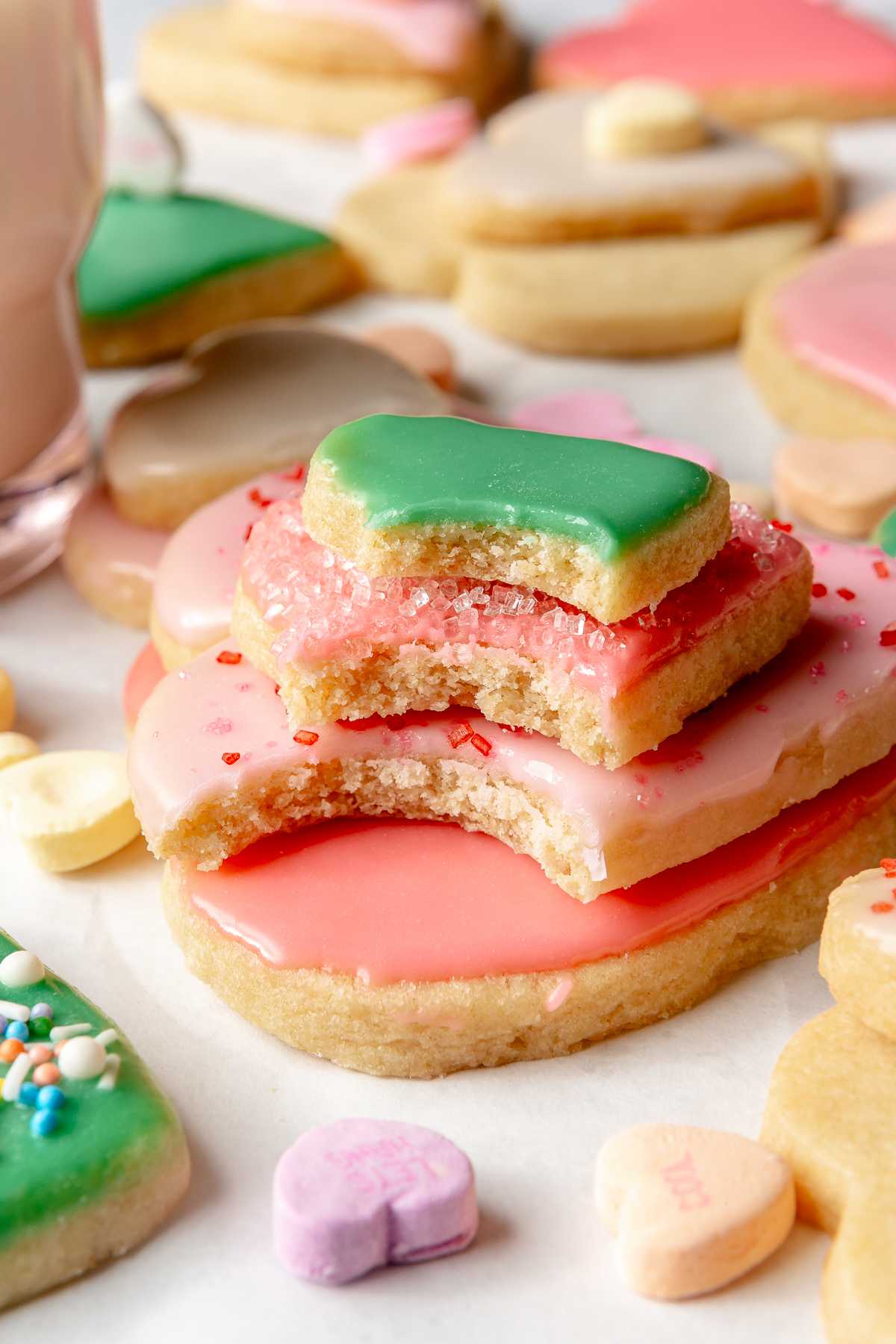 Iced cookies stacked with a bite taken out of each one.