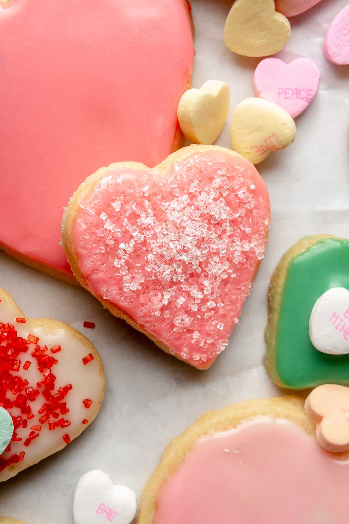 Heart cookie with pink icing and sprinkles.