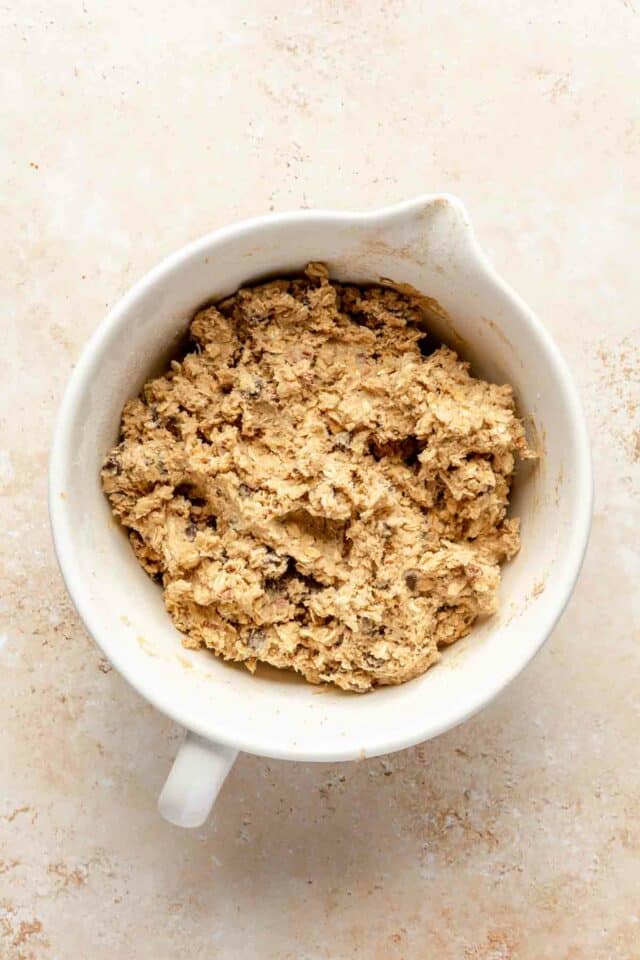Cowboy cookie dough in a white bowl.