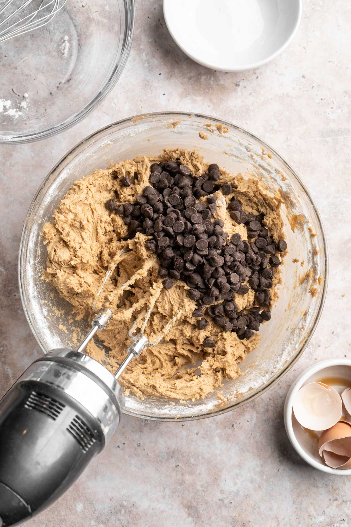 Folding chocolate chips into cookie dough.