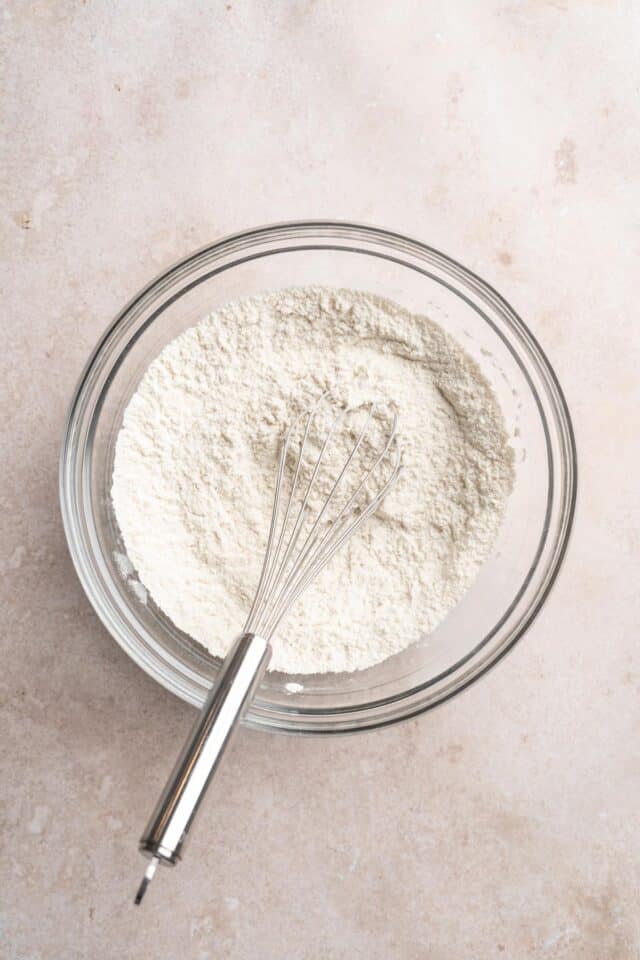 Whisking flour with baking soda and salt in a large bowl.