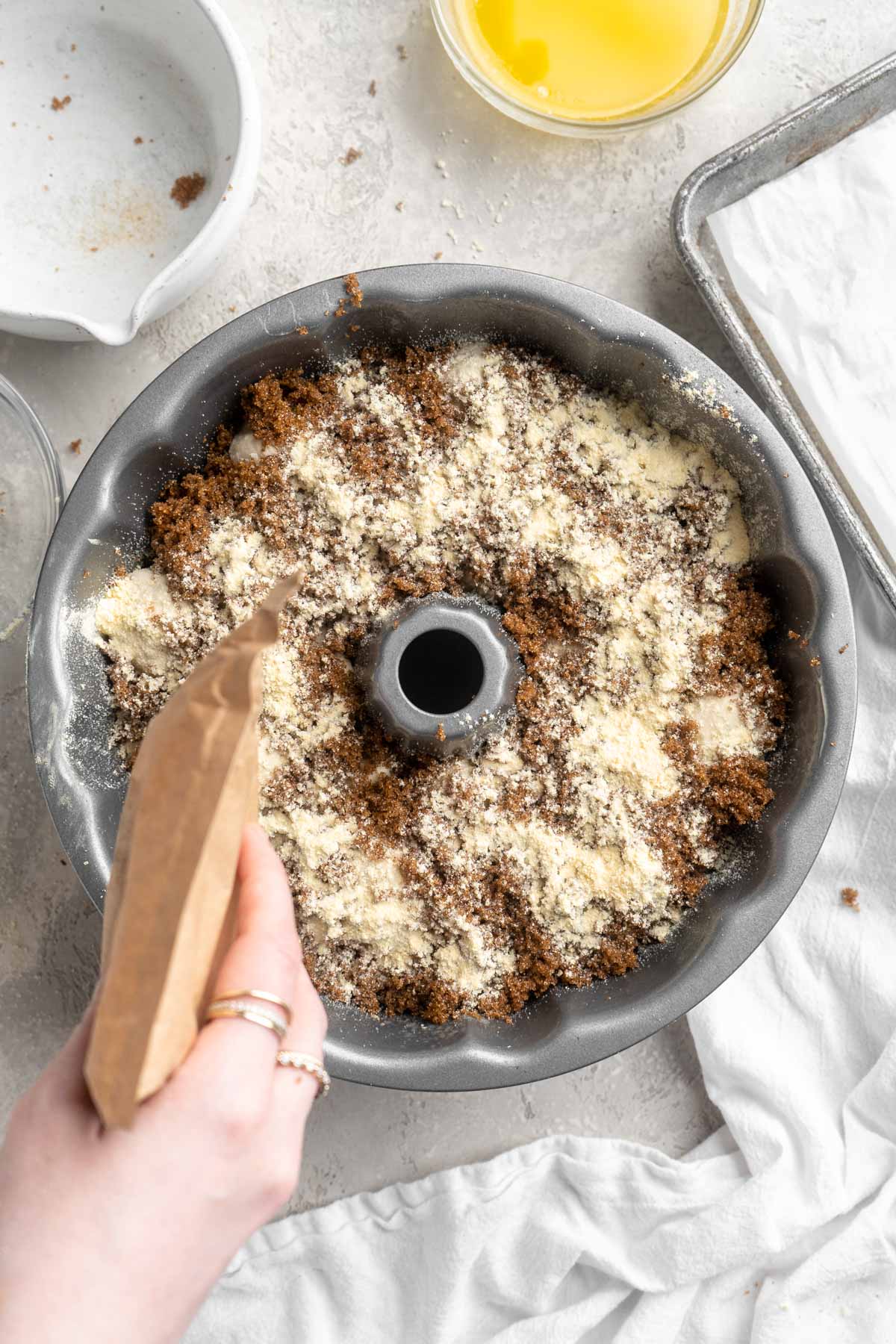 Sprinkling dry butterscotch pudding mix over brown sugar in a bundt pan.