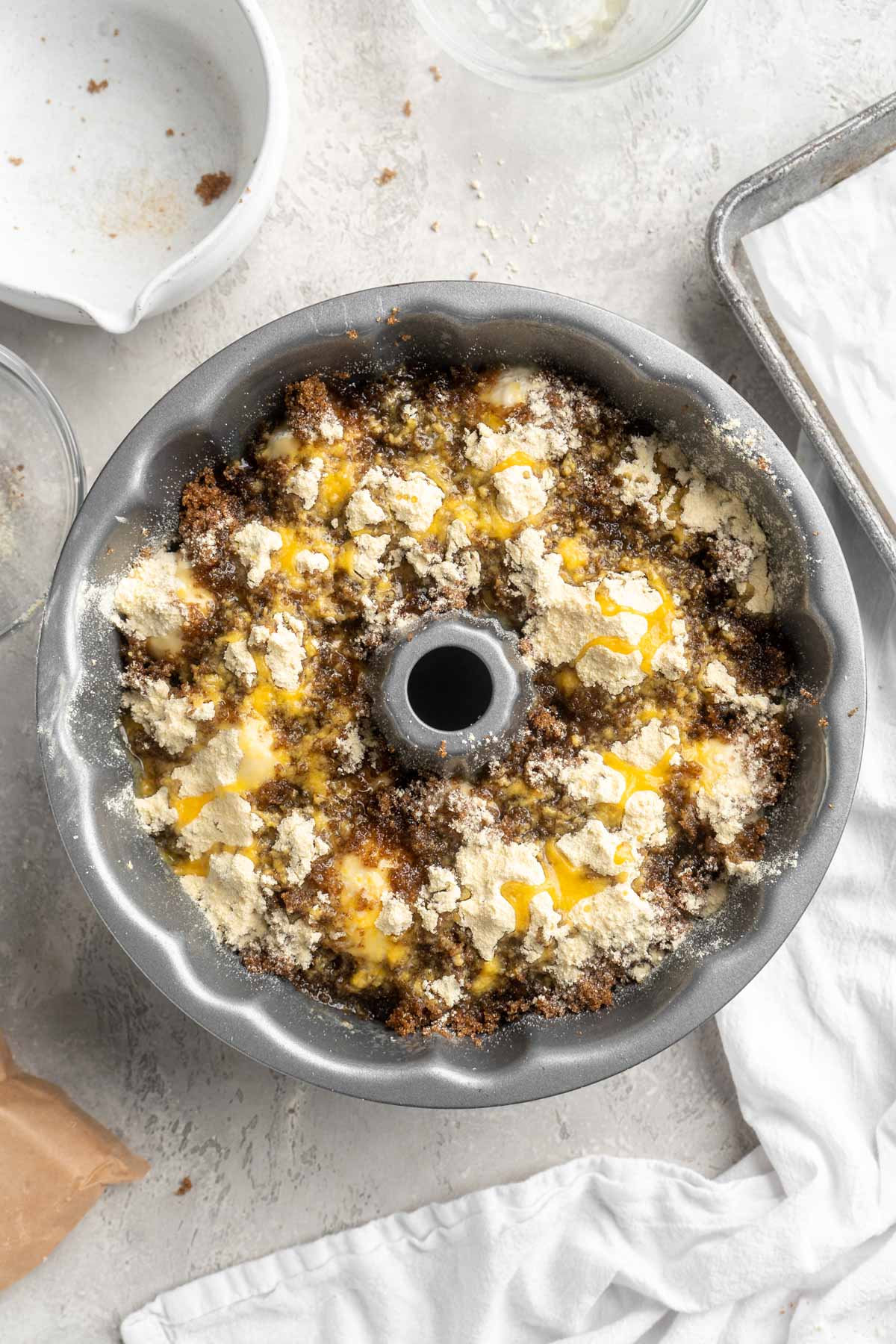 Melted butter drizzled over rolls in a bundt pan.