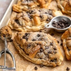 Cookie croissant on a sheet pan with mini chocolate chips.
