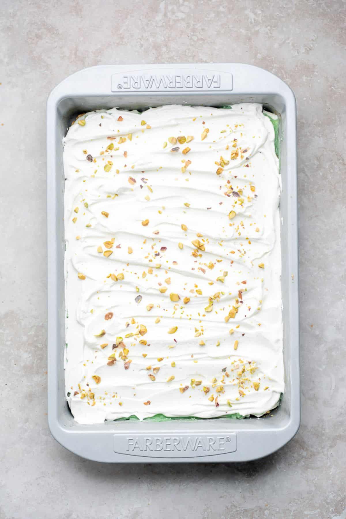 Chopped pistachios sprinkled over whipped topping.