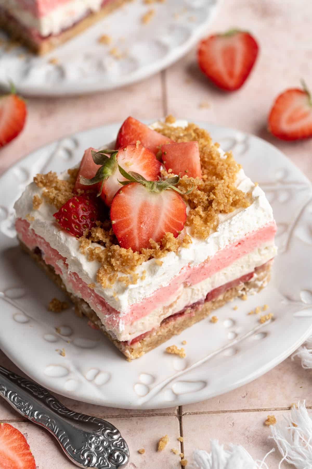 Layered strawberry delight dessert on a plate.