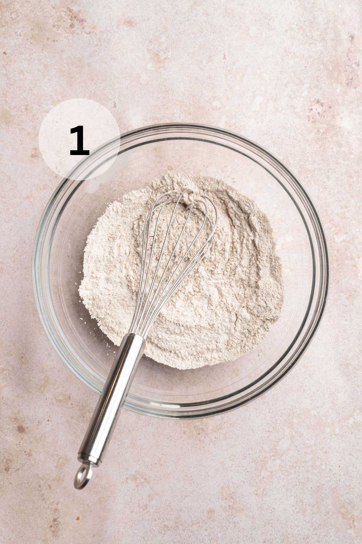 Whisking flour with baking powder and baking soda.