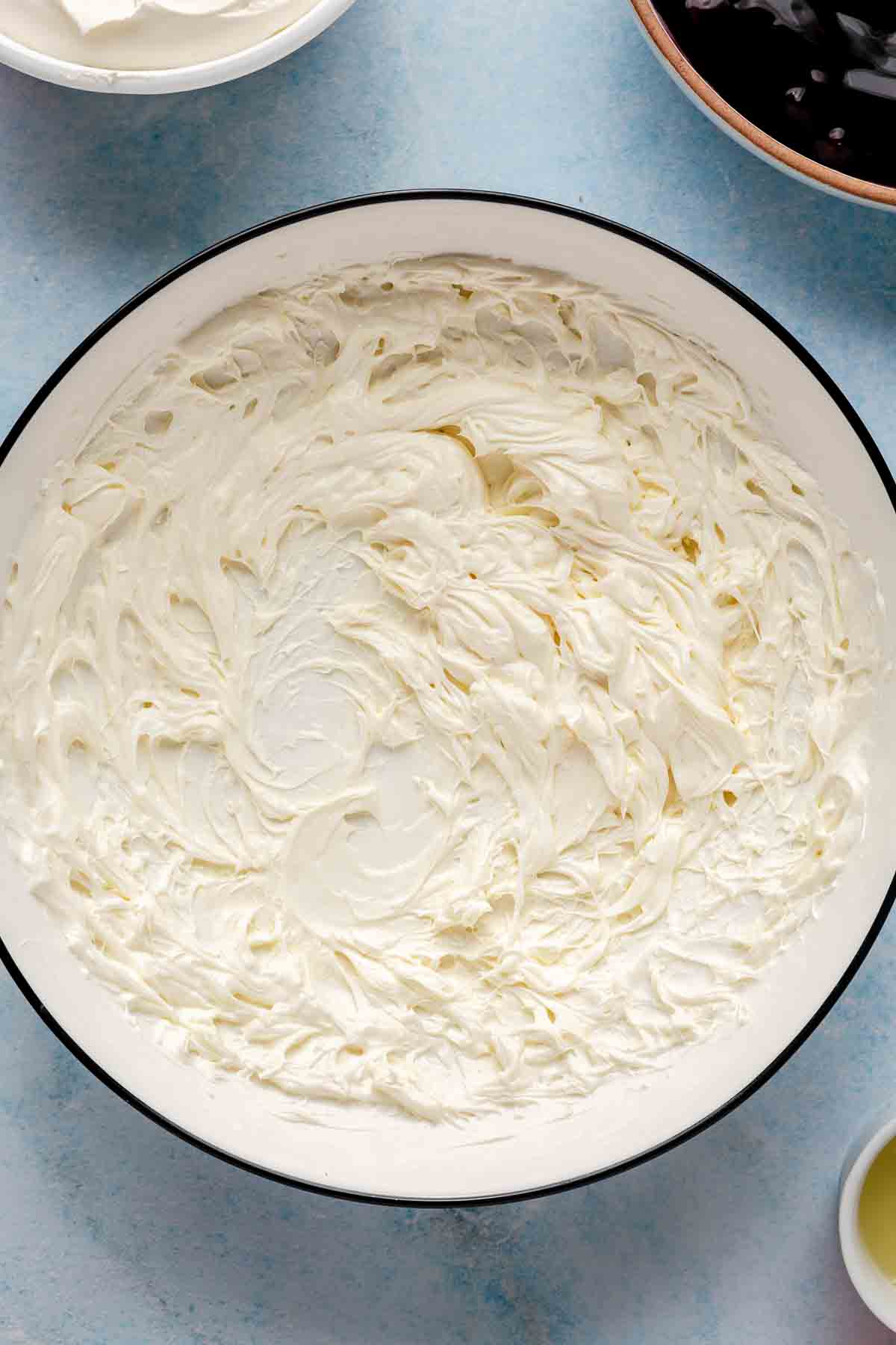 Cream cheese beat in a bowl.