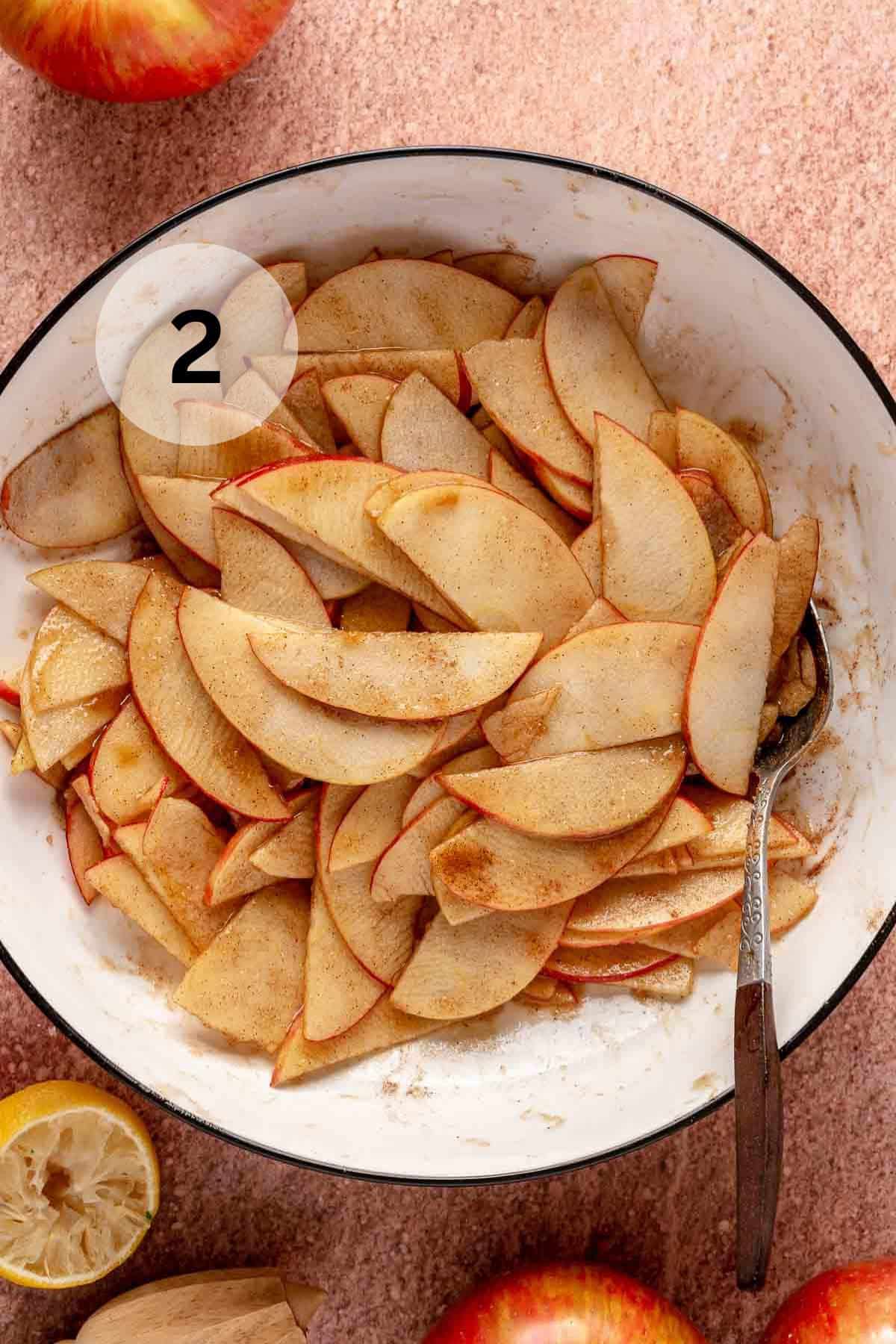 Stirring apple slices with brown sugar, cinnamon and lemon juice.
