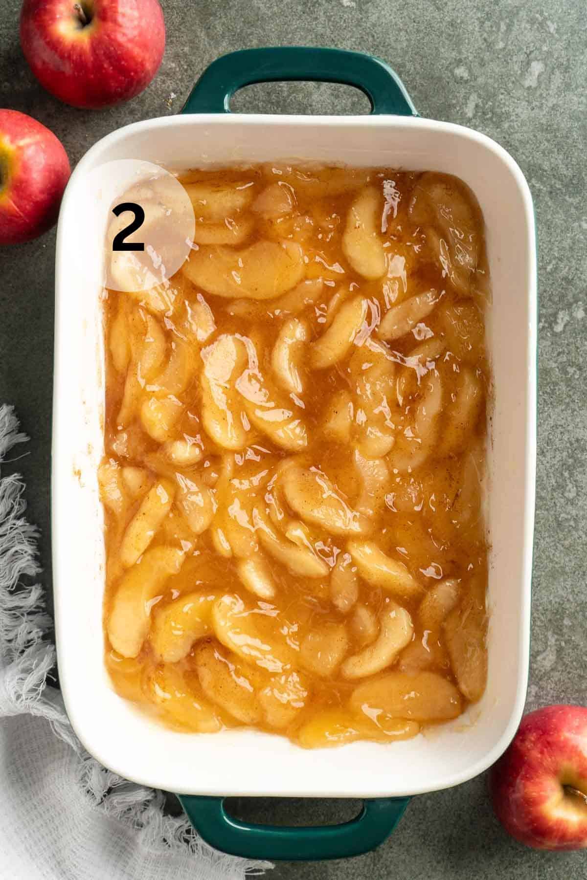 Apple pie filling spread in a 9x13-inch casserole dish.