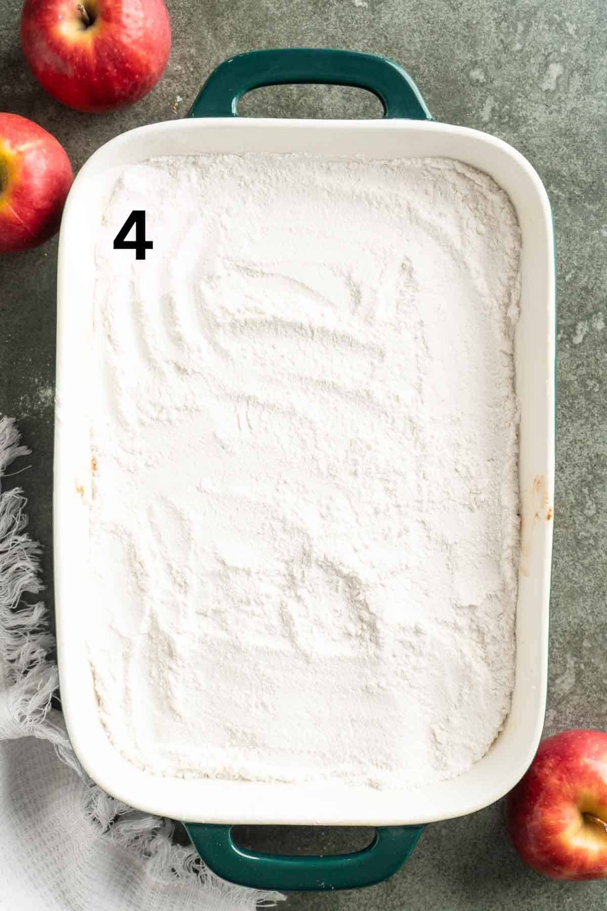 Dry cake mix sprinkled over the top of apple fruit filling.