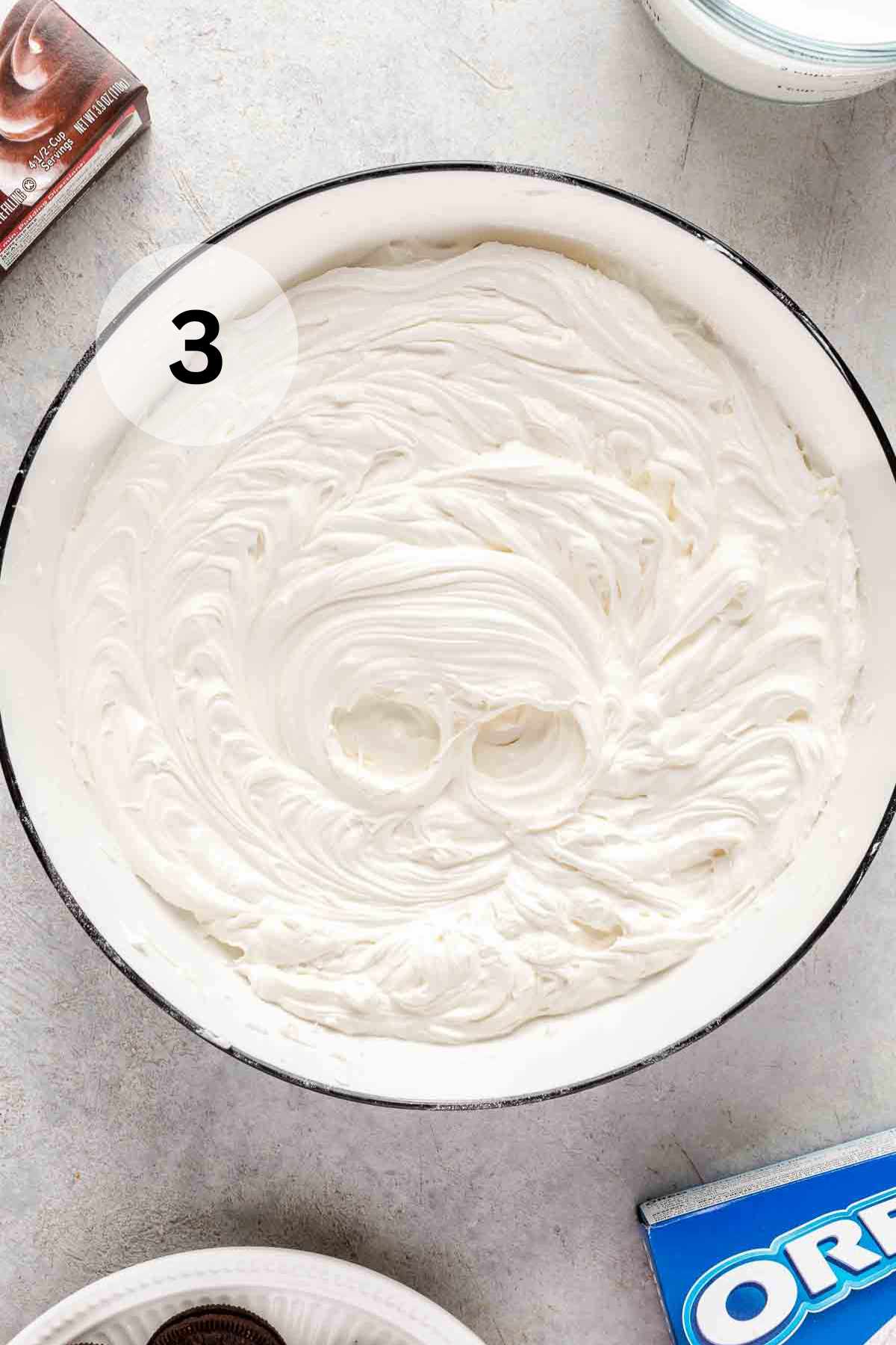 Fluffy cream cheese and Cool Whip mixture in a bowl.