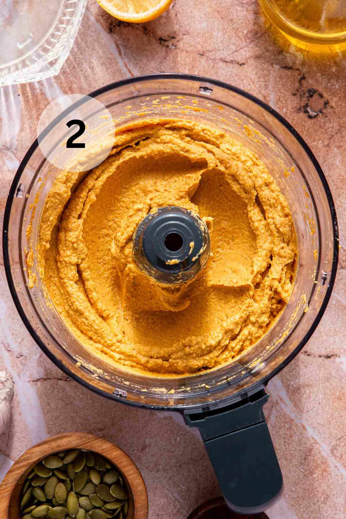 Pumpkin hummus in a food processor.