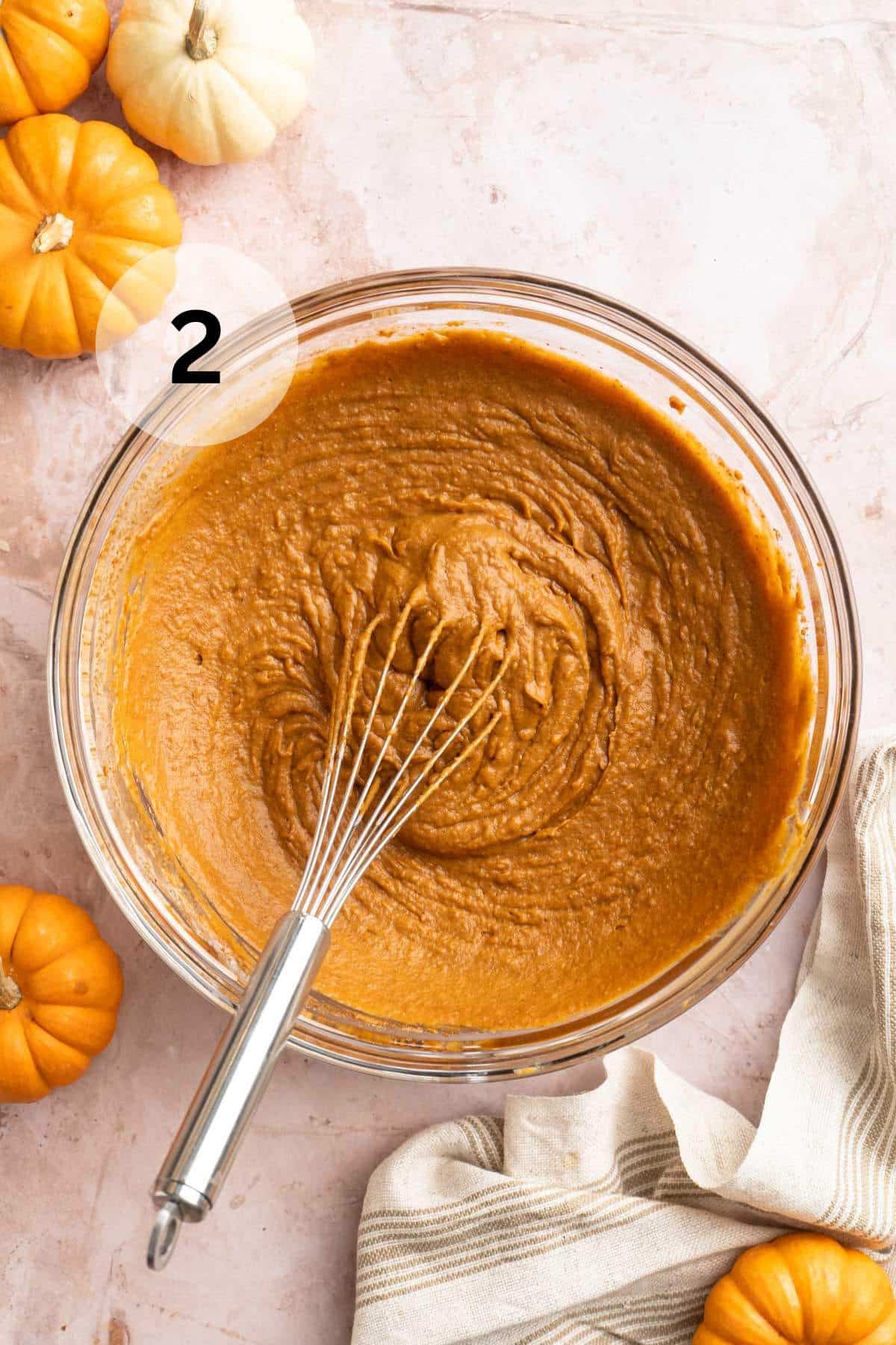 Whisking pumpkin puree with coconut cream and coconut sugar.